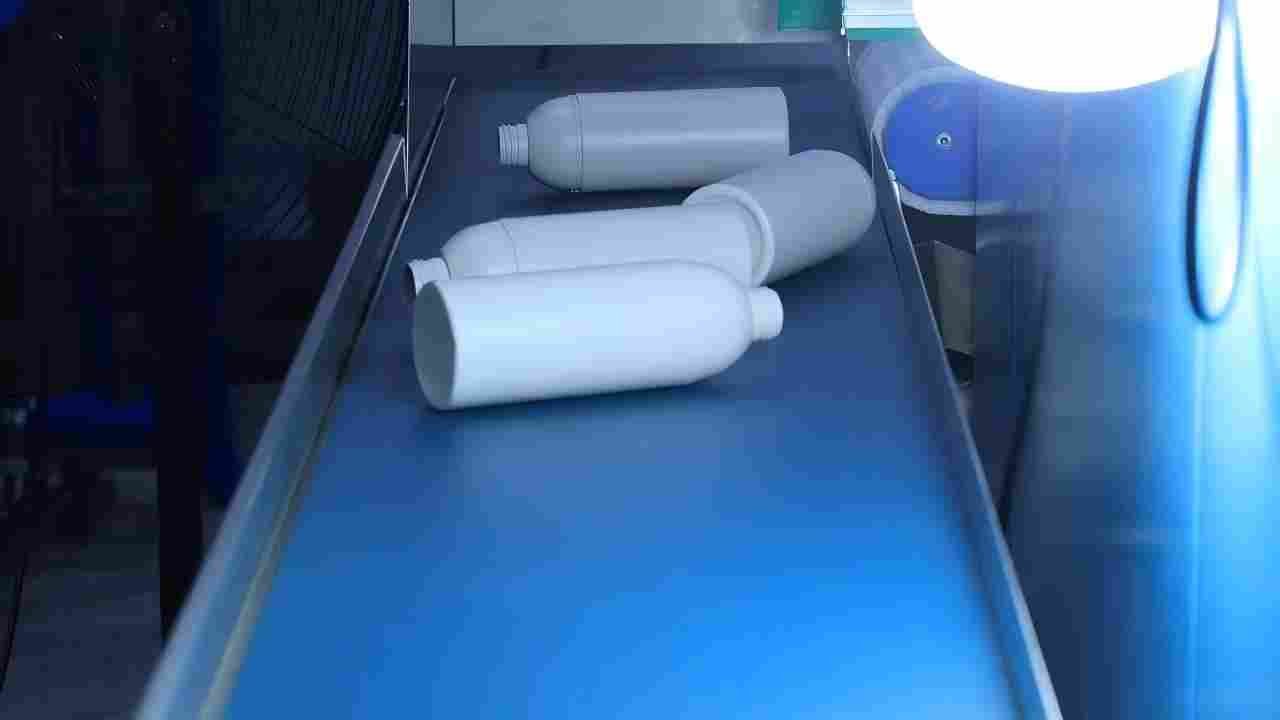 medical pharmaceutical bottles on conveyor belt of all electric blow molding machine