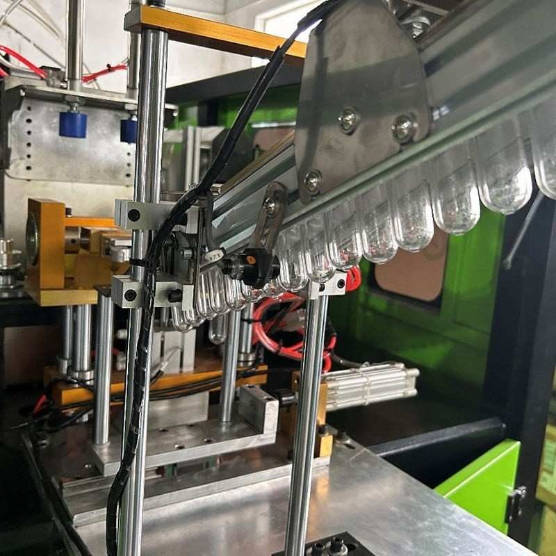 Preform Sorting and Feeding Slide Track Automatic PET preform sorting and feeding slide track leading to preform infeed robot gripper mechanism — Sailwin