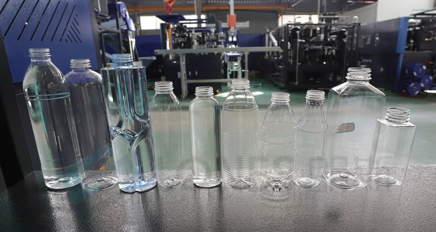 Finished crystal clear PET water and beverage bottles in round and square container geometries produced on precision blow molding equipment — Sailwin