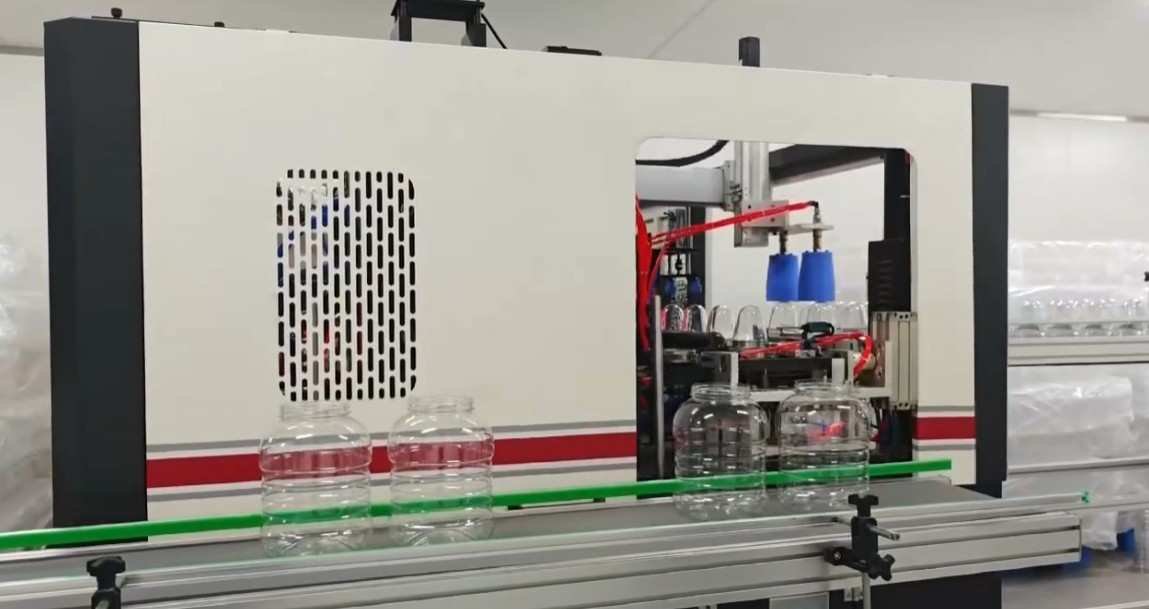 Full automatic high efficiency PET blow molding machine featuring heavy duty enclosed safety doors and automated outfeed conveyor — Sailwin