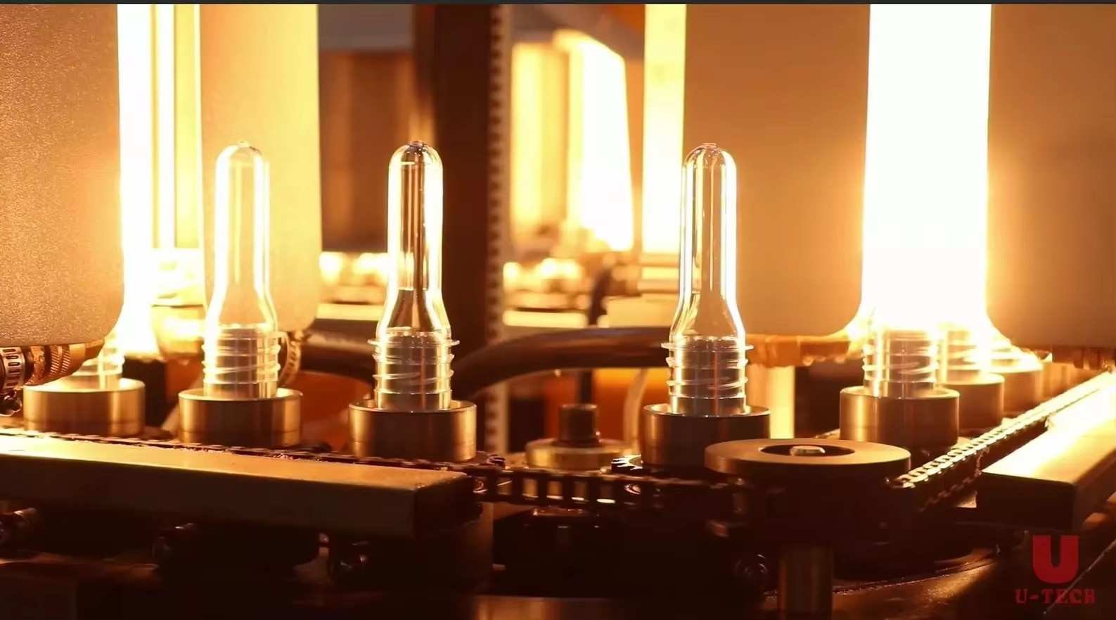 Infrared heating tunnel equipped with independent multi-zone lamps heating PET preforms on continuous rotary spindles — Sailwin Machinery