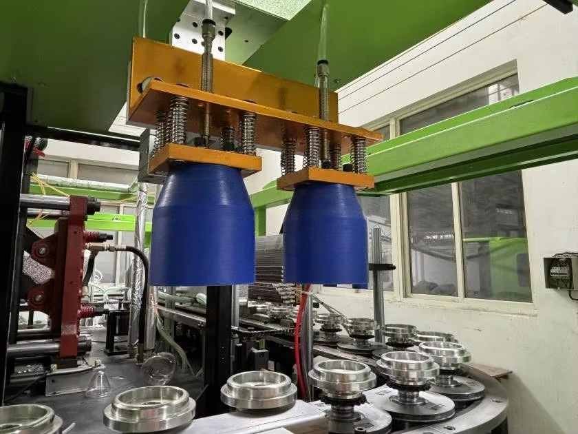 Rotary Spindles and Neck Protection Shielding Large diameter preform neck protection caps and rotary heating spindles for wide mouth jar blow molding equipment — Sailwin