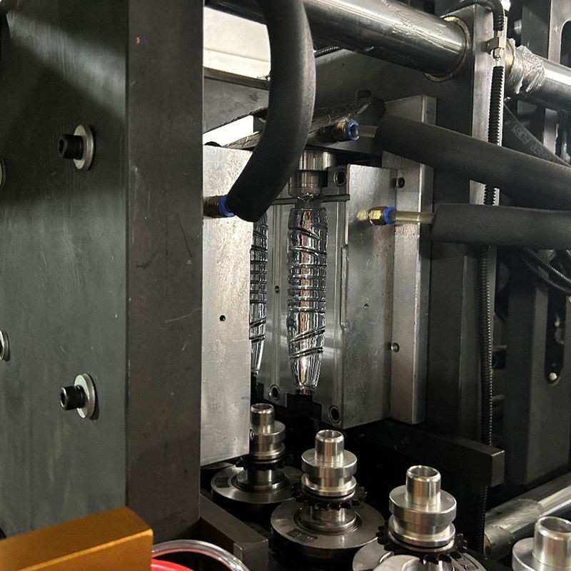 Precision Mold Tooling and Cooling Channels Precision aluminum bottle mold cavity with cooling water hoses and clamping platen in PET blow molding machine — Sailwin