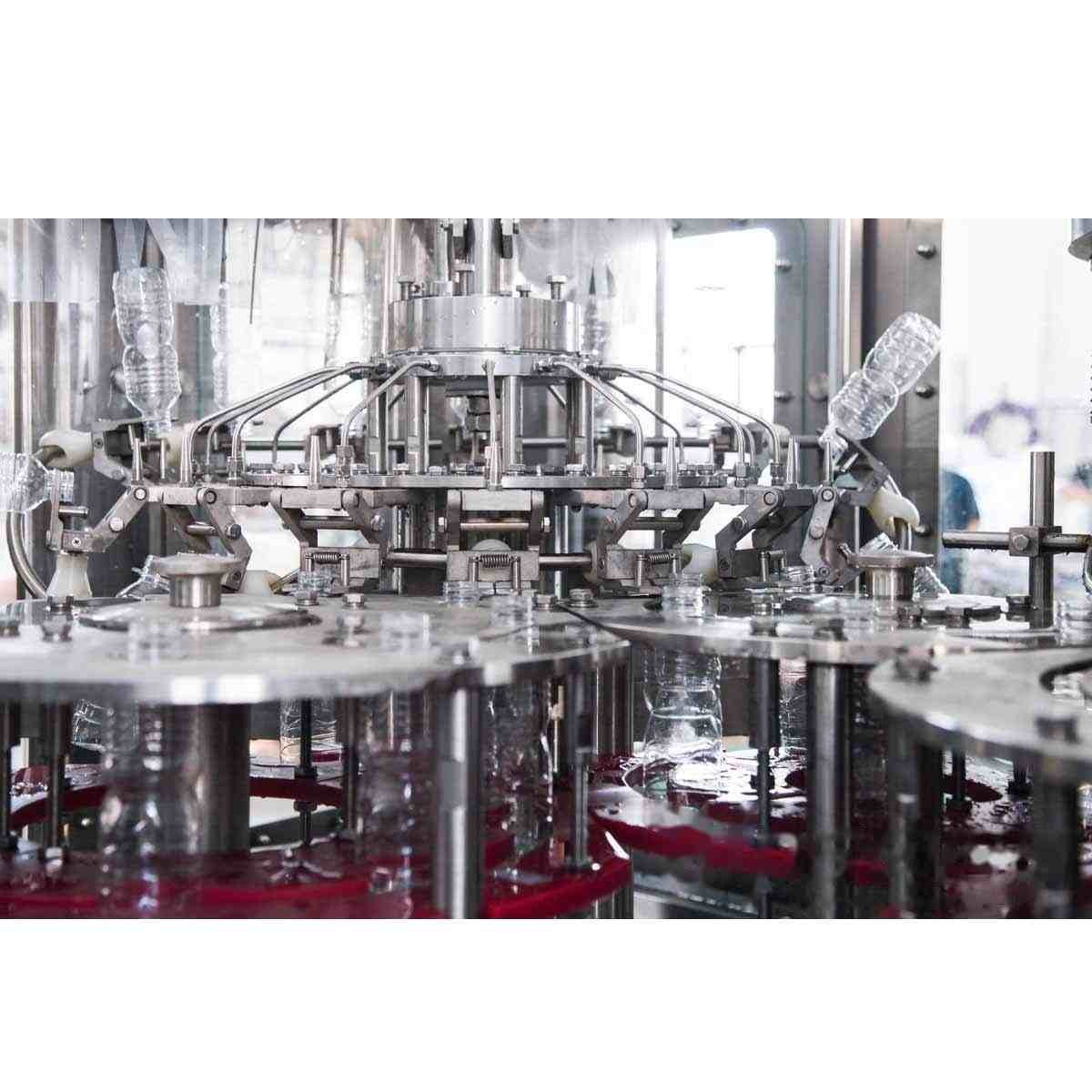 High speed rotary liquid filling valves filling mineral water bottles in plant